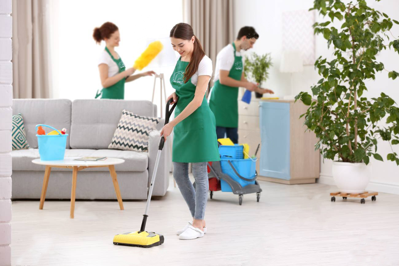 Cleaning service team working in living room